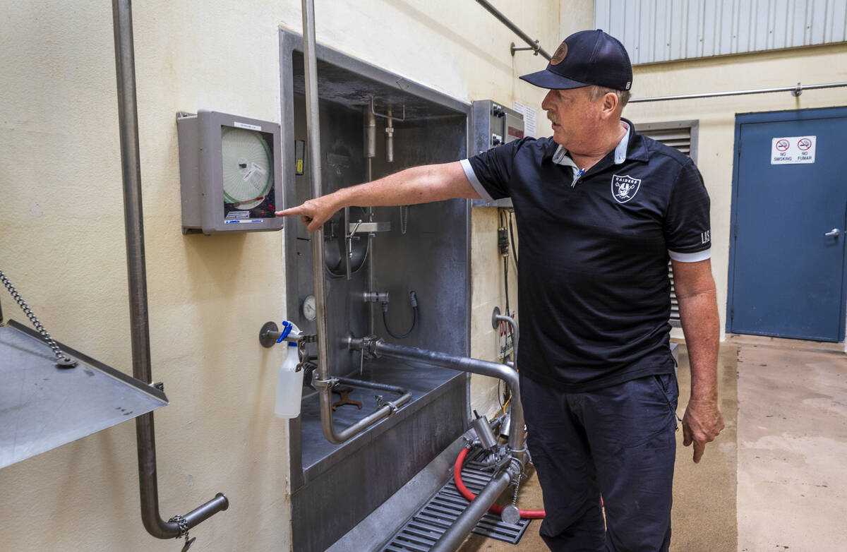 Ed Goedhart, manager of Ponderosa Dairies, shows how the just produced milk is already chilled ...