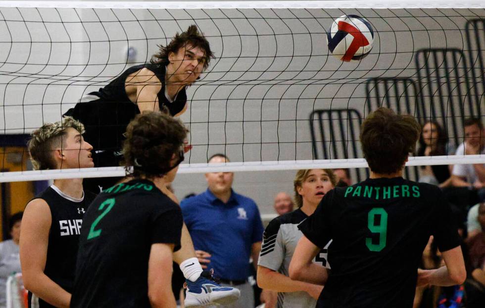 Shadow Ridge's Brady Beko (14) spikes the ball against Palo Verde's Colton Mendez (2) and Palo ...