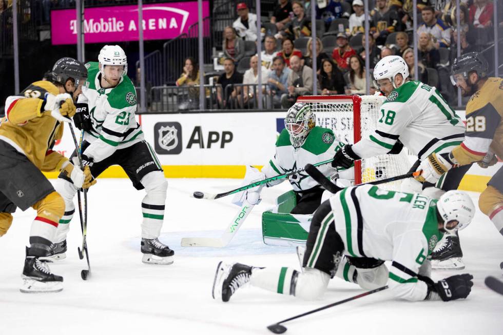 Dallas Stars center Max Domi (18) deflects a shot by Golden Knights center Teddy Blueger (53) w ...