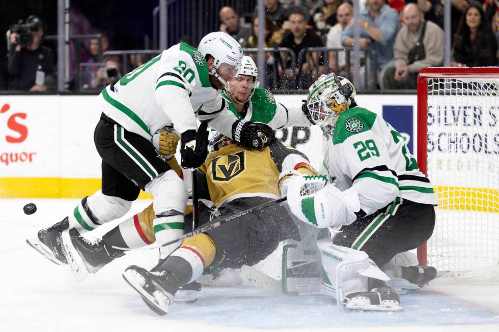 Golden Knights right wing Keegan Kolesar (55) falls into the net after Dallas Stars goaltender ...