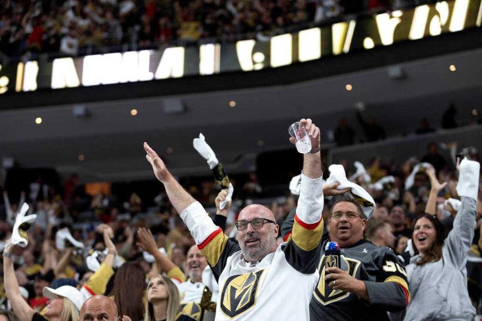 Golden Knights fans celebrate after Knights center Brett Howden (21) scored the game-winning go ...