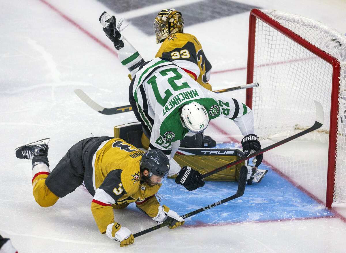 Golden Knights defenseman Brayden McNabb (3) and Dallas Stars left wing Mason Marchment (27) tu ...