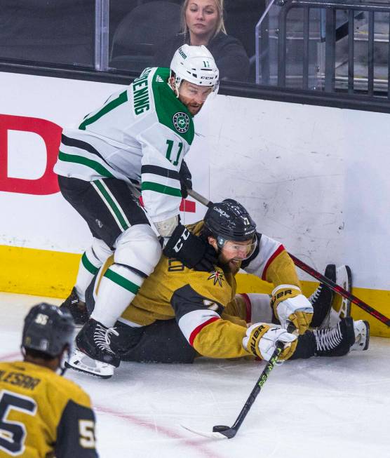 Golden Knights defenseman Alex Pietrangelo (7) still controls the puck after being pushed down ...