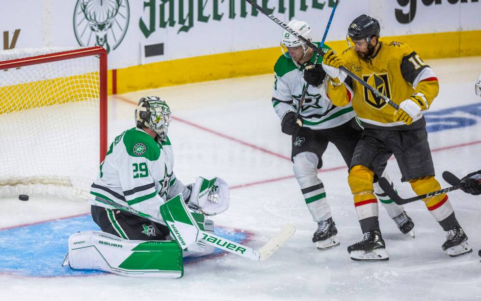 Golden Knights center Nicolas Roy (10) and Dallas Stars defenseman Esa Lindell (23) watch the p ...