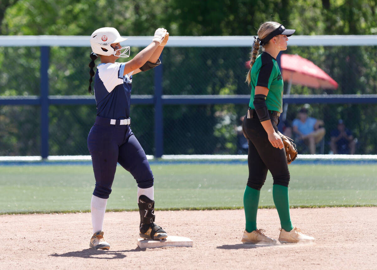 Centennial High's Amanda Campos-Colon (9) gestures toward her teammates after hitting a double ...