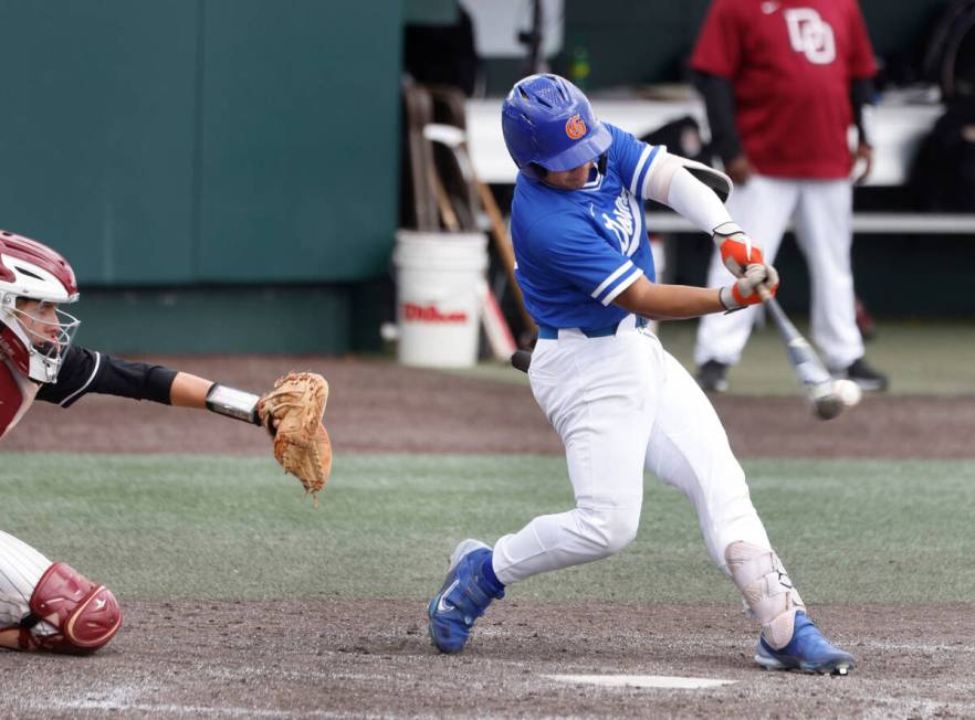 Bishop Gorman's Marcus Matias connects for a hit against Desert Oasis during a Class 5A high sc ...