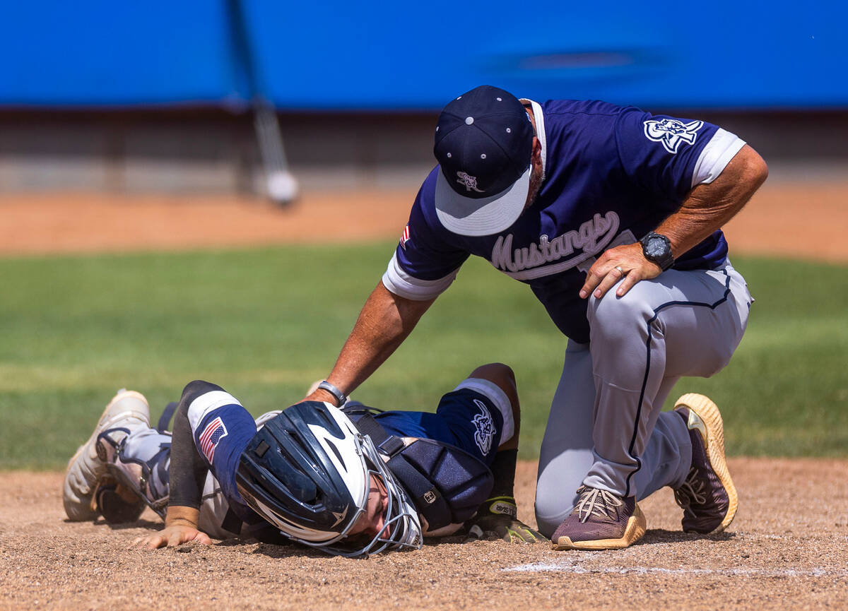 Shadow Ridge C Austin Lynn is down at the plate after taking a tipped pitch against a Foothill ...