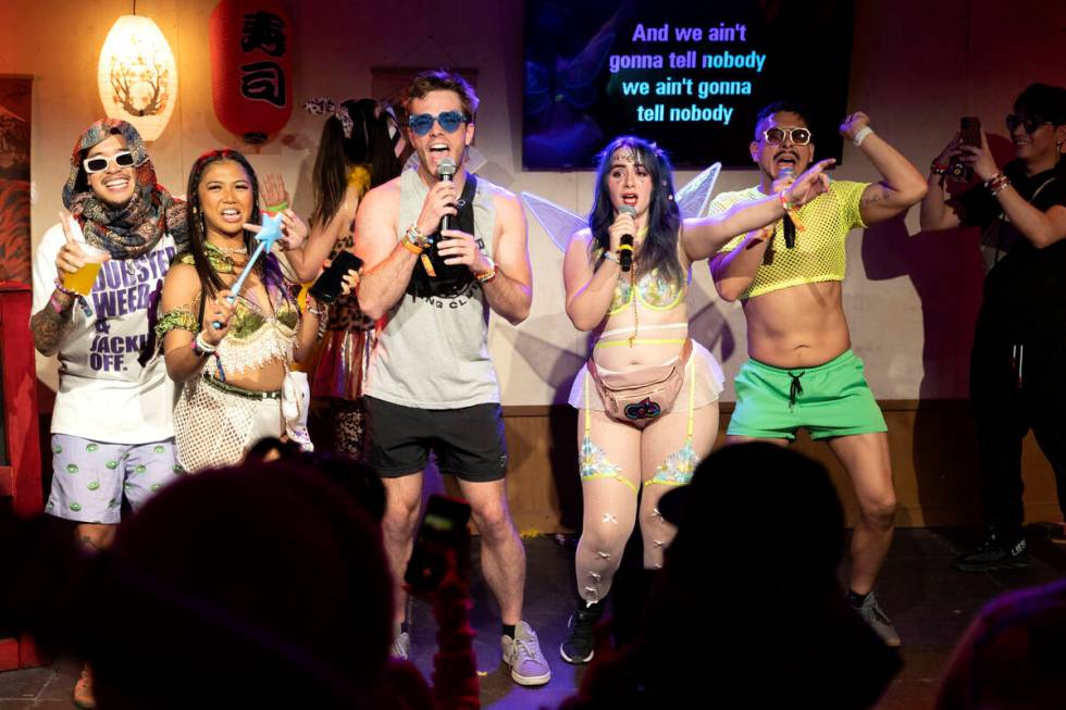 Attendees sing karaoke at Tokyo Karaoke during the second day of electronic dance music festiva ...