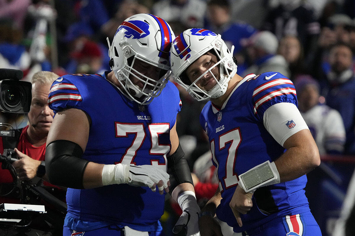 Buffalo Bills guard Greg Van Roten (75) and quarterback Josh Allen (17) warm up before an NFL f ...