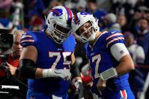 Buffalo Bills guard Greg Van Roten (75) and quarterback Josh Allen (17) warm up before an NFL f ...