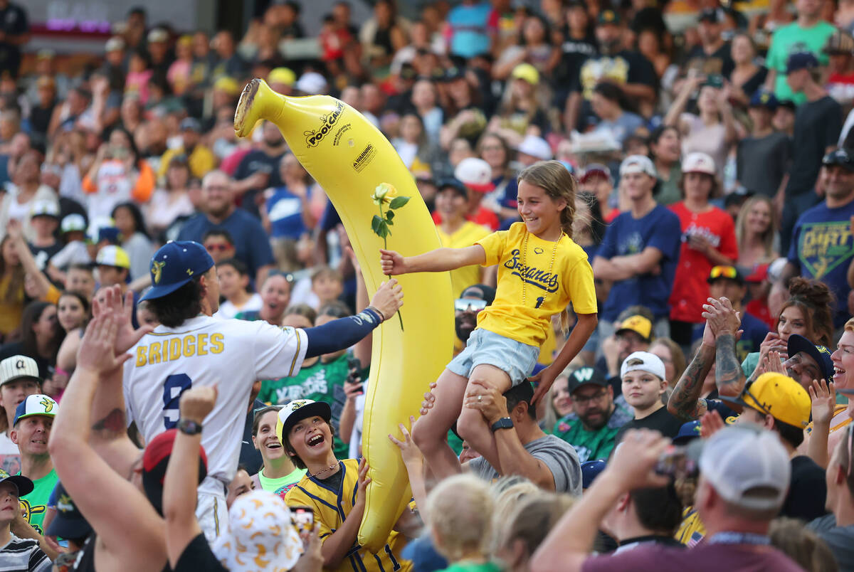 Brooklyn Dalzell, 10, receives a rose from Savannah Bananas’ Noah Bridges during the Ban ...