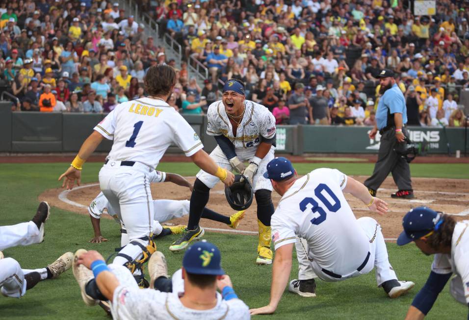 Savannah Bananas’ Dakota McFadden (24), center, celebrates his home run with his team du ...