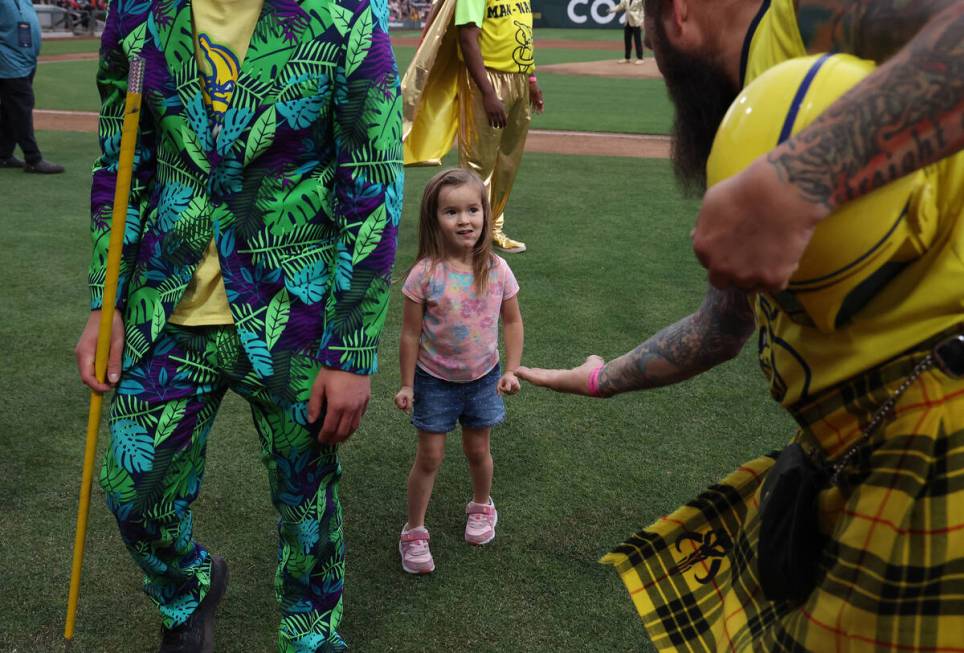 Savannah Bananas fan Noelle Casebolt, 3, of Overton, looks to slap hands after playing a game o ...