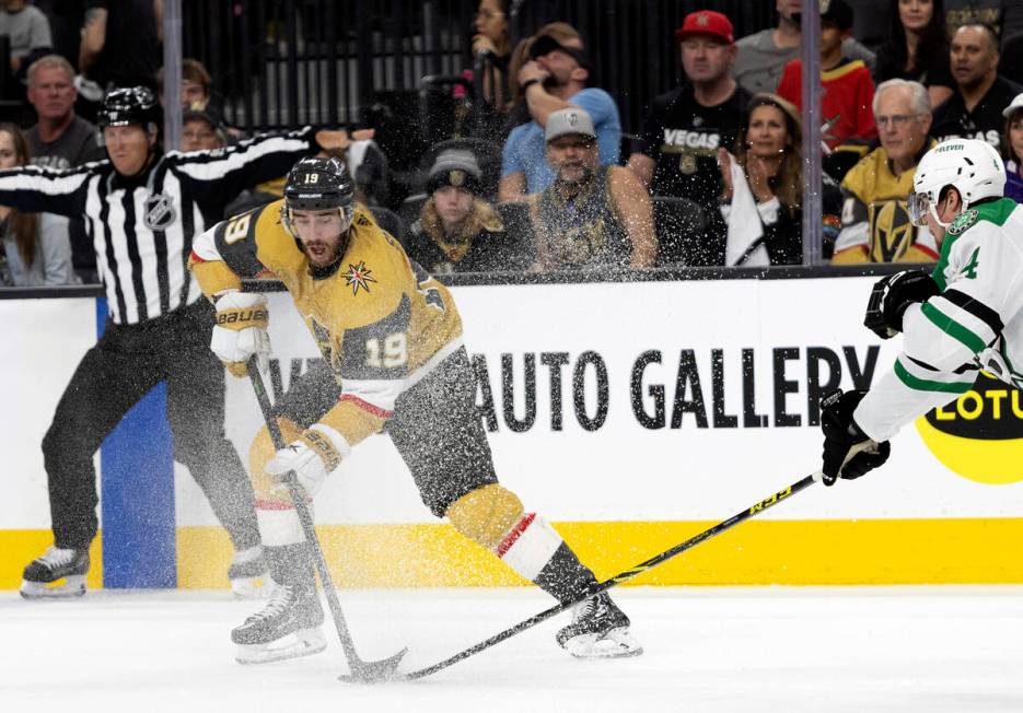 Golden Knights right wing Reilly Smith (19) battles for the puck with Dallas Stars defenseman M ...