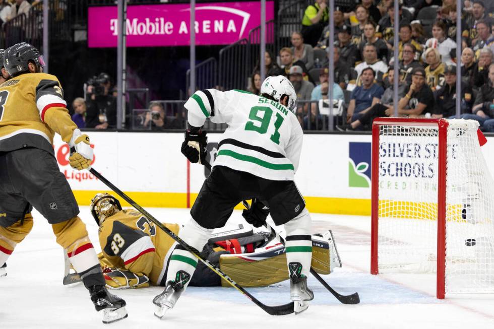 Golden Knights goaltender Adin Hill (33) dives but misses the save on Dallas Stars left wing Ja ...