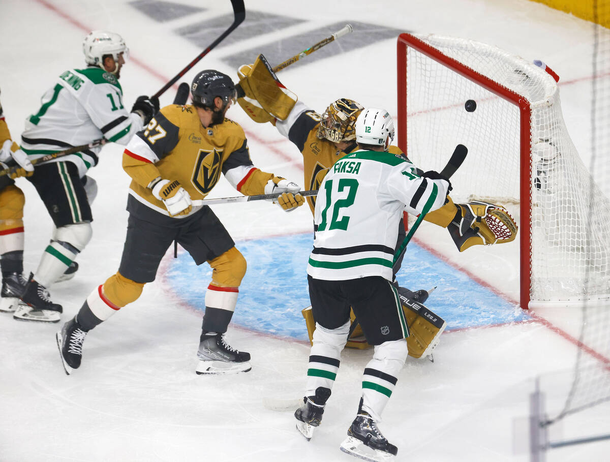 Golden Knights goaltender Adin Hill (33) cannot stop a shot by Dallas Stars center Dallas Stars ...