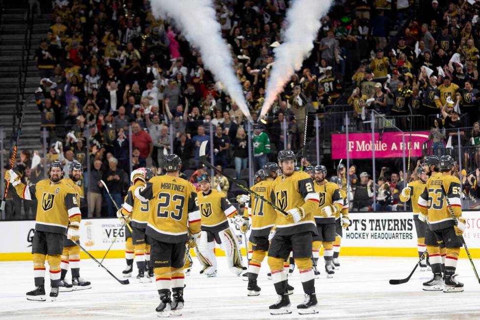 The Golden Knights celebrate after winning Game 2 of the NHL hockey Stanley Cup Western Confere ...