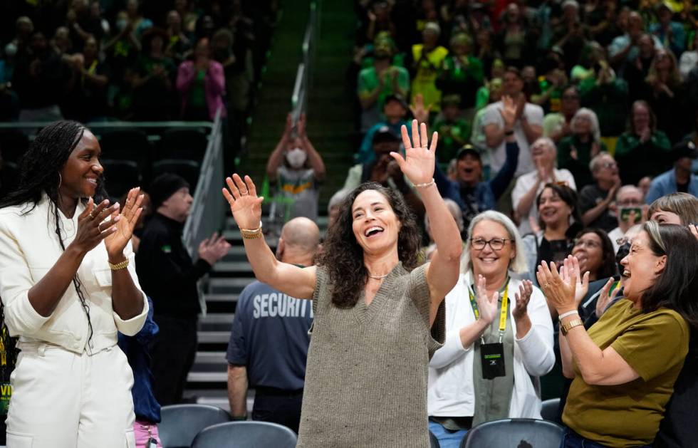 Former Seattle Storm player Sue Bird, center, acknowledges the crowd as former teammate and Sto ...