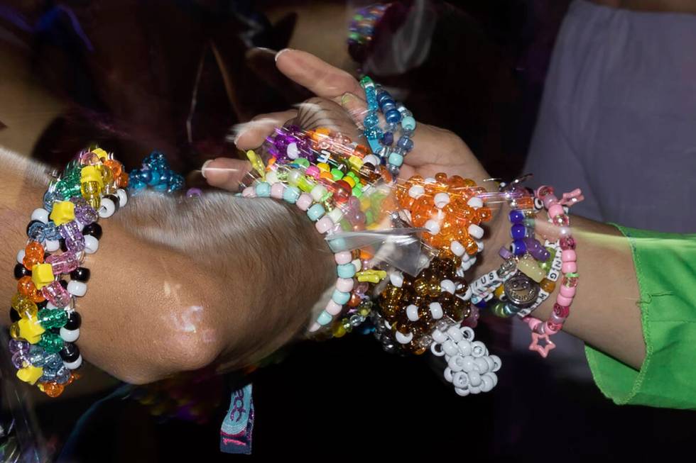 Attendees exchange bracelets as a sign of PLUR culture during the second day of electronic danc ...