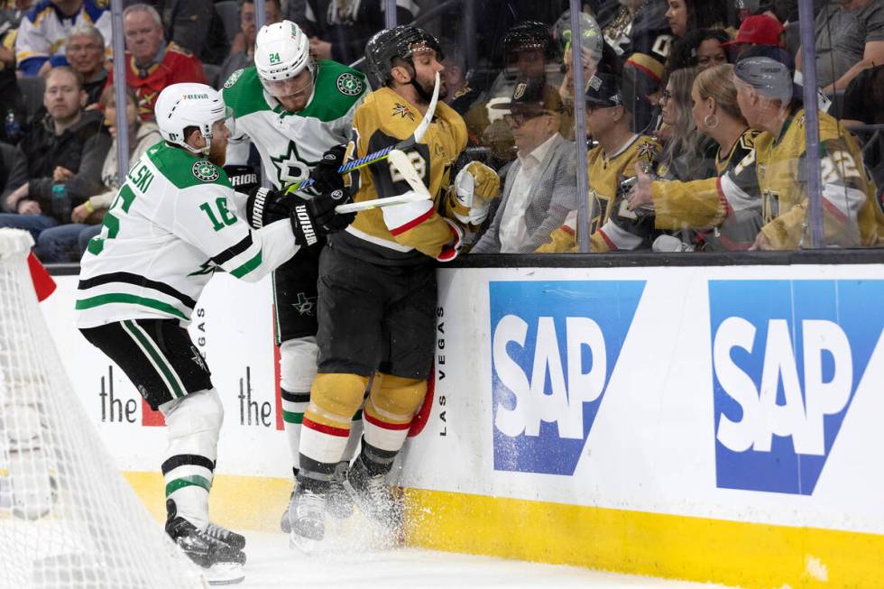 Dallas Stars centers Roope Hintz (24) and Joe Pavelski (16) hit Golden Knights defenseman Alec ...