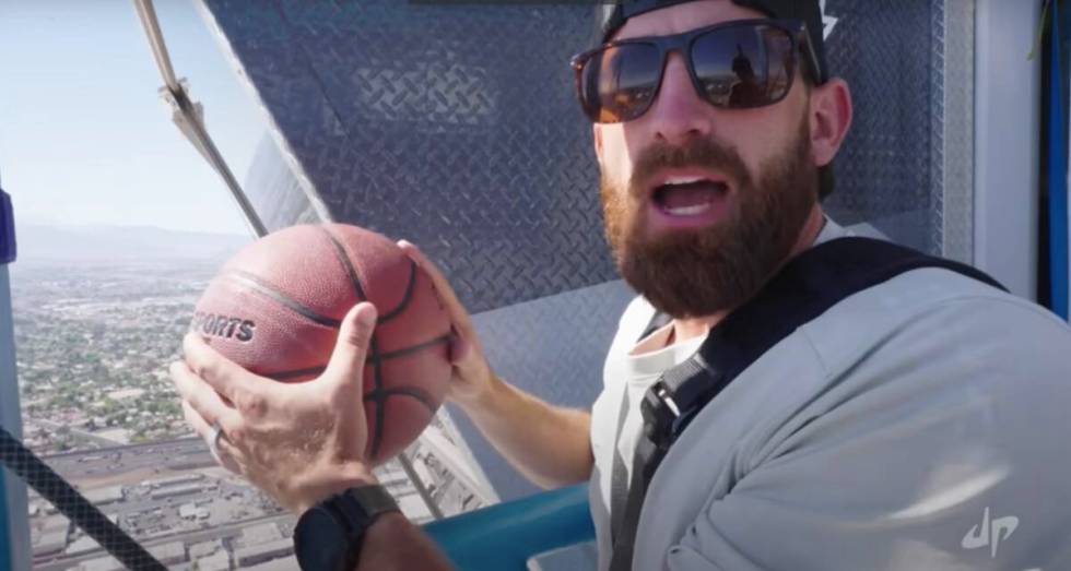 A screenshot of Dude Perfect co-founder Tyler Toney attempts the world's highest basketball sho ...