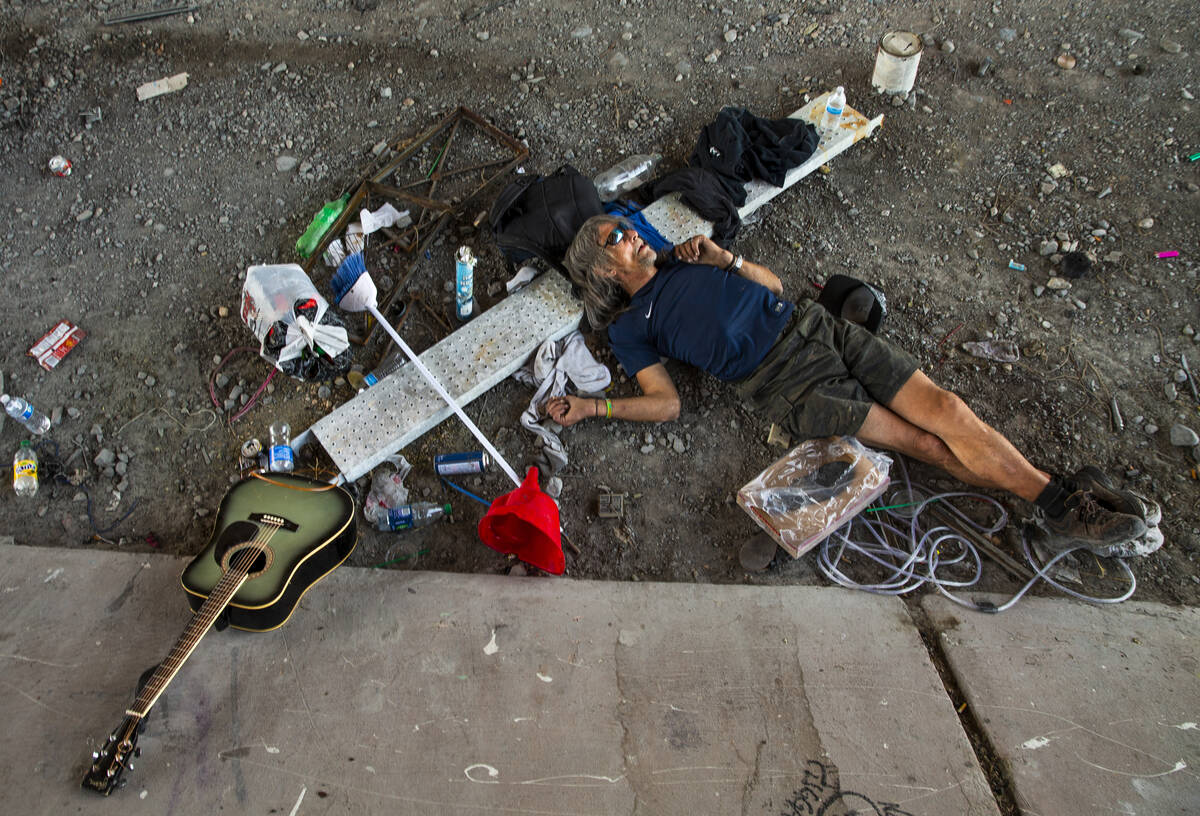 A homeless individual takes a nap beside some possessions below the Flamingo Road overpass on T ...