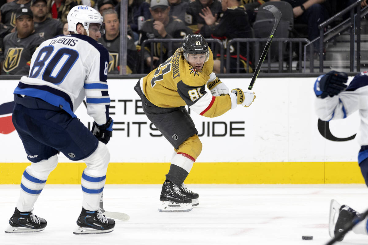 Golden Knights right wing Jonathan Marchessault (81) shoots while Jets left wing Pierre-Luc Dub ...