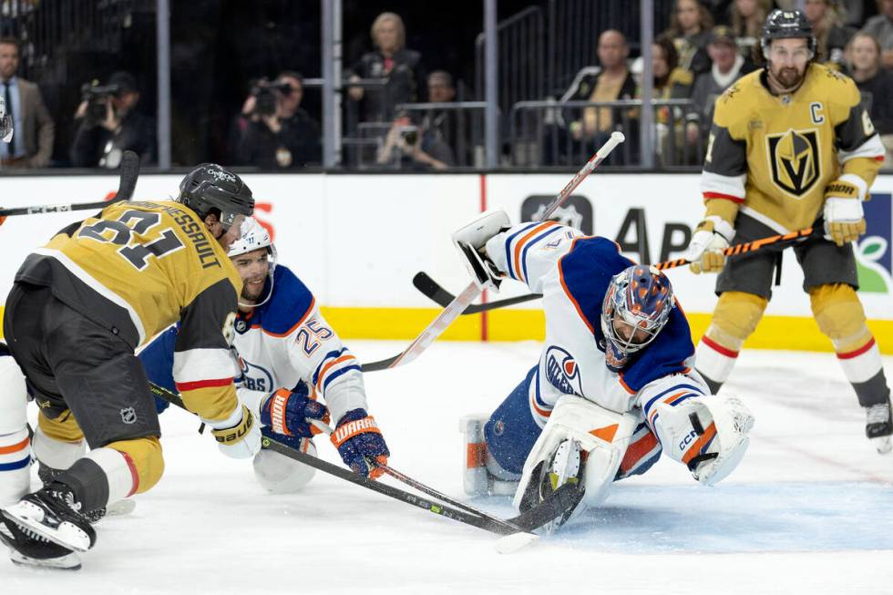 Edmonton Oilers goaltender Stuart Skinner (74) makes a glove save against Golden Knights right ...