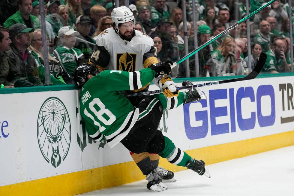 Dallas Stars center Max Domi (18) and Vegas Golden Knights defenseman Nicolas Hague (14) collid ...