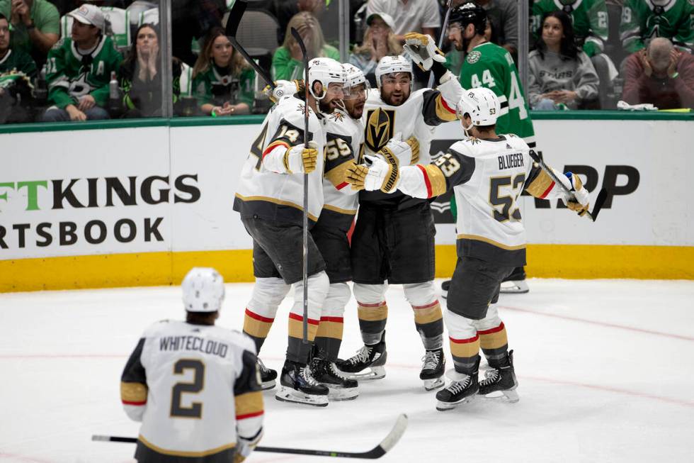 The Golden Knights surround left wing William Carrier (28) after he scored the third goal durin ...