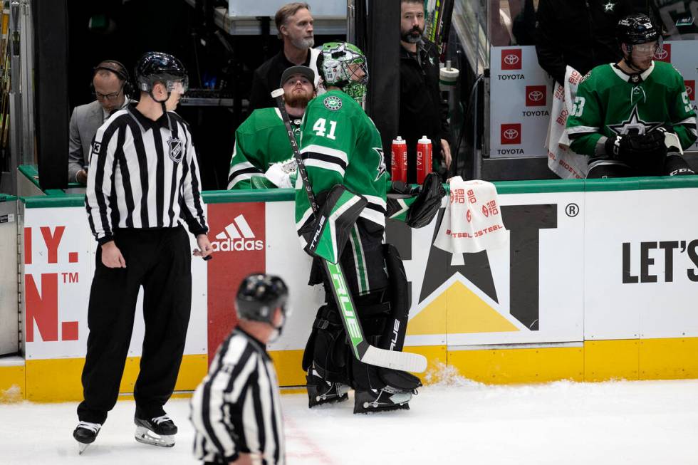 Dallas Stars goaltenders Jake Oettinger, center left, and Scott Wedgewood (41) break from play ...