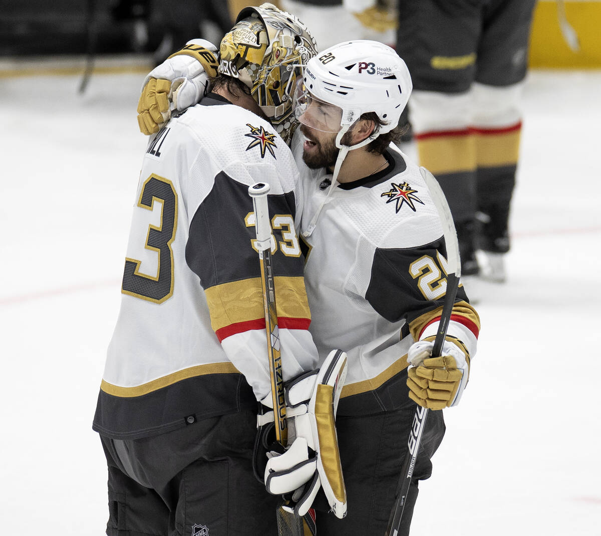 Golden Knights goaltender Adin Hill (33) and center Chandler Stephenson (20) celebrate after wi ...