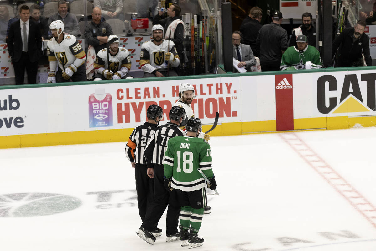 Golden Knights right wing Mark Stone (61) and Dallas Stars center Max Domi (18) have a disagree ...