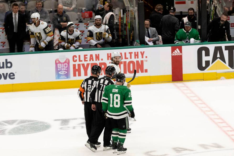 Golden Knights right wing Mark Stone (61) and Dallas Stars center Max Domi (18) have a disagree ...