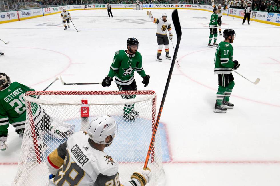 Golden Knights left wing William Carrier (28) skates to celebrate with right wing Keegan Kolesa ...