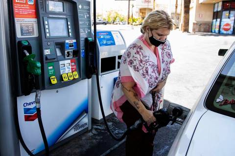 Crystal Tippit of Orange County, Calif., pumps gas at Chevron on Tropicana Avenue, on Wednesday ...