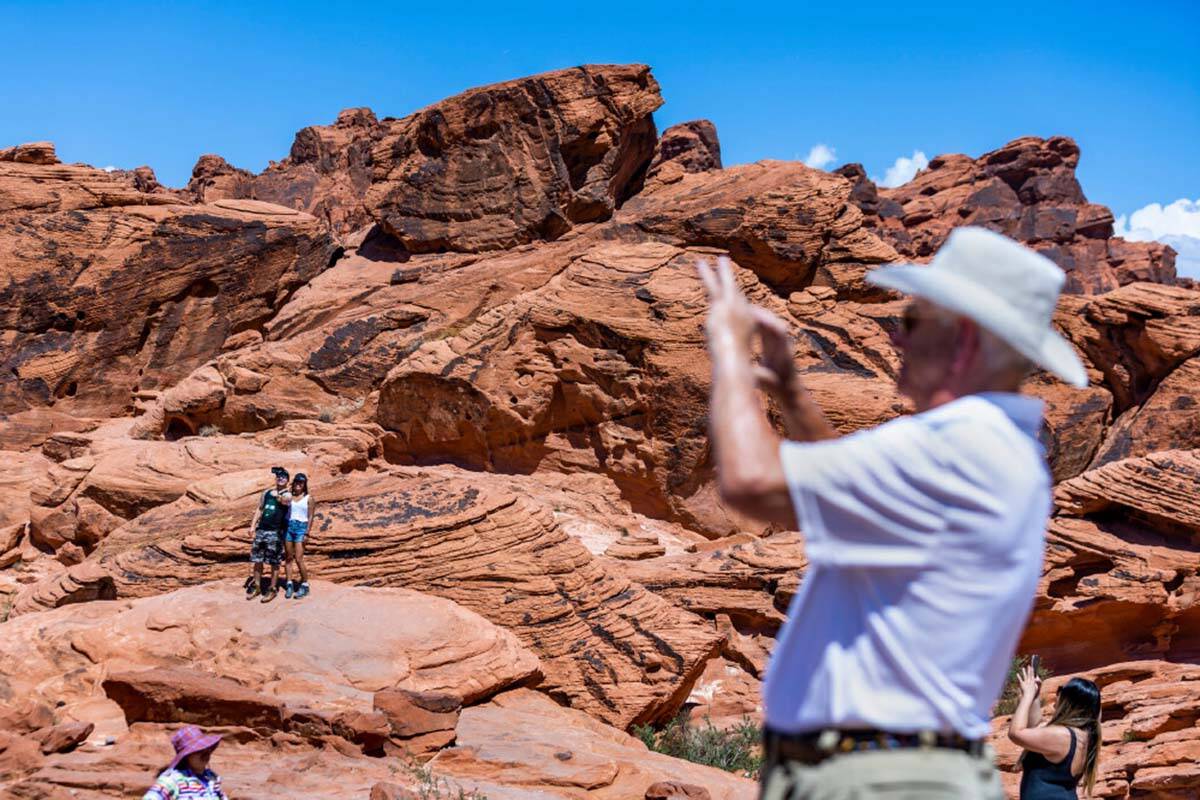 Visitors take in the Beehives rock formations in the Valley of Fire State Park in June 2022. (L ...