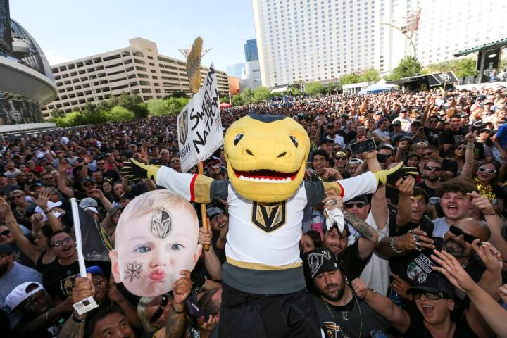 Vegas Golden Knights mascot Chance the Golden Gila Monster jumps on fans before Game 1 of the N ...