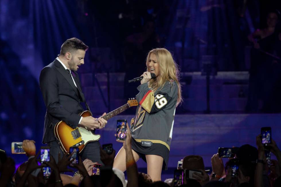 Celine Dion, shown with guitarist Kaven Girouard, sports a Marc-Andre Fleury Vegas Golden Knigh ...