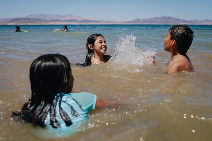 Emily Diaz, top/left, 13, splashes Armando Tirre III, 8, on Sunday, May 28, 2023, at Lake Mead, ...