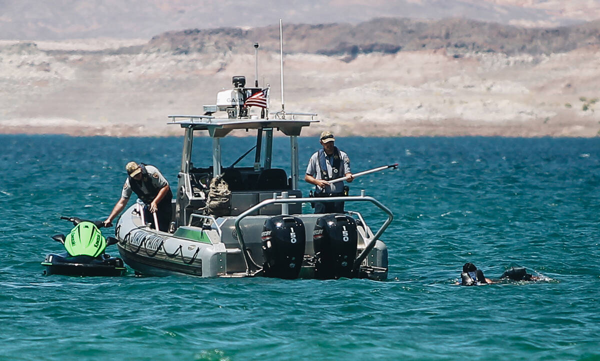 Lake Mead water patrol holds onto a jet ski after stopping the riders on Sunday, May 28, 2023, ...