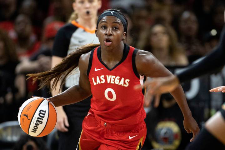 Aces guard Jackie Young (0) dribbles up the court during the first half of a WNBA preseason bas ...