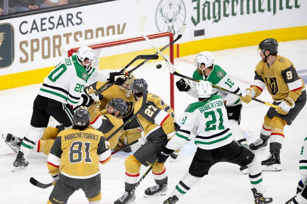 Dallas Stars left wing Jason Robertson (21) scores on Golden Knights goaltender Adin Hill (33) ...