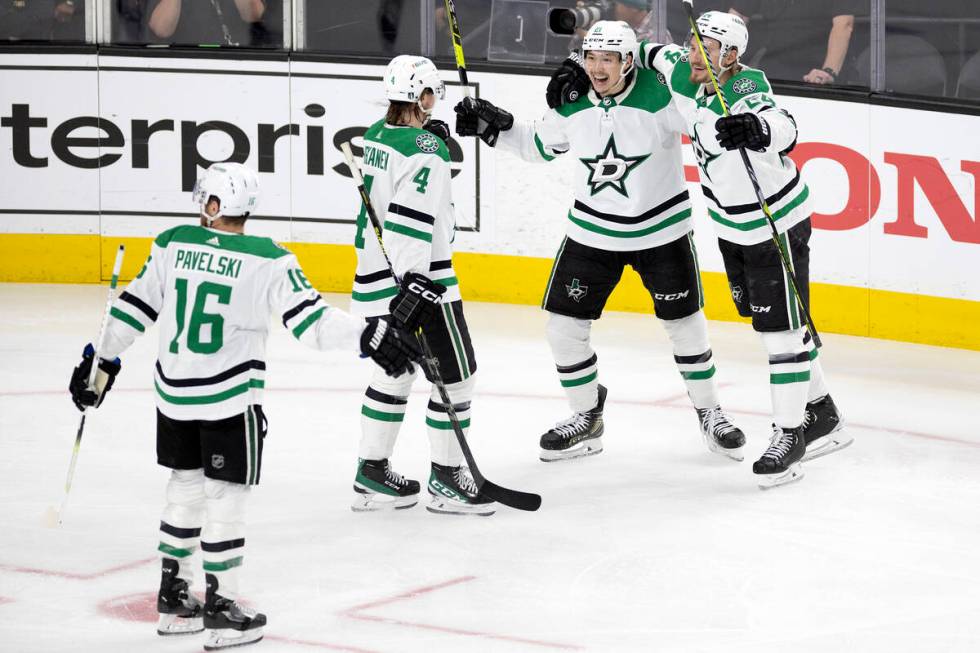 The Dallas Stars congratulate Dallas Stars left wing Jason Robertson, third from left, during t ...