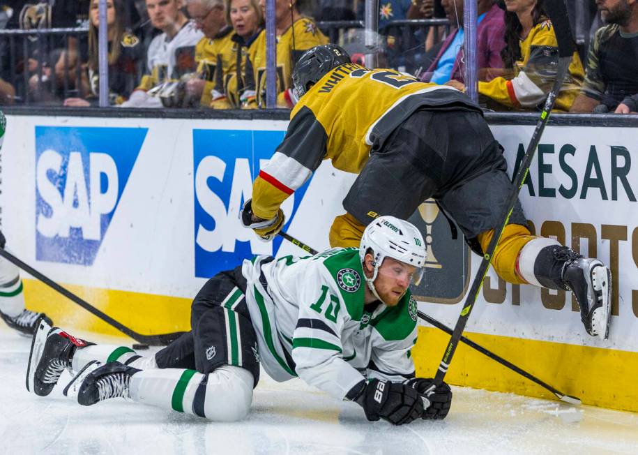 Golden Knights defenseman Zach Whitecloud (2) takes down Dallas Stars center Ty Dellandrea (10) ...