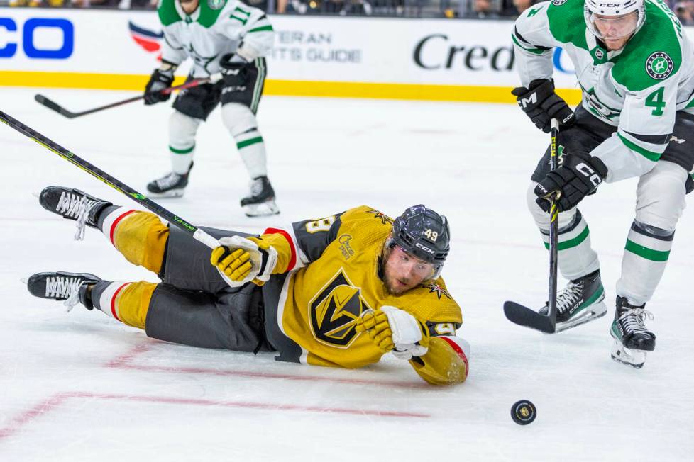 Golden Knights center Ivan Barbashev (49) watches the puck slide by as Dallas Stars defenseman ...