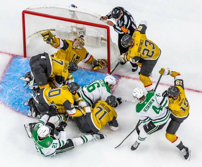 Golden Knights goaltender Adin Hill (33) shows he has the puck in near miss by Dallas Stars lef ...