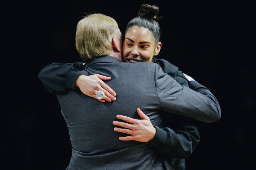Las Vegas Aces guard Kelsey Plum hugs Aces owner Mark Davis after receiving her championship ri ...