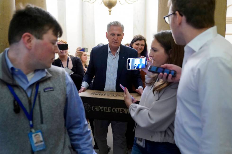 House Speaker Kevin McCarthy of Calif., carries food for members of the press covering deb ...