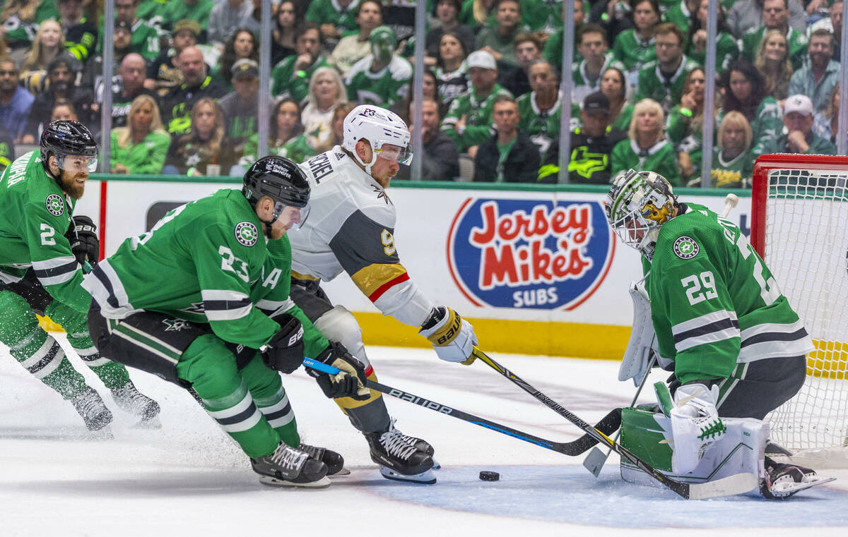 Golden Knights center Jack Eichel (9) loses the puck on a drive between Dallas Stars goaltender ...